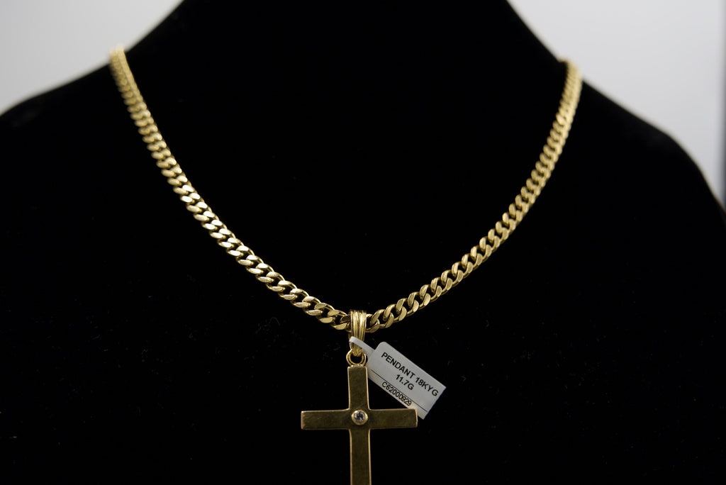Gold chain necklace with a cross pendant on a black background