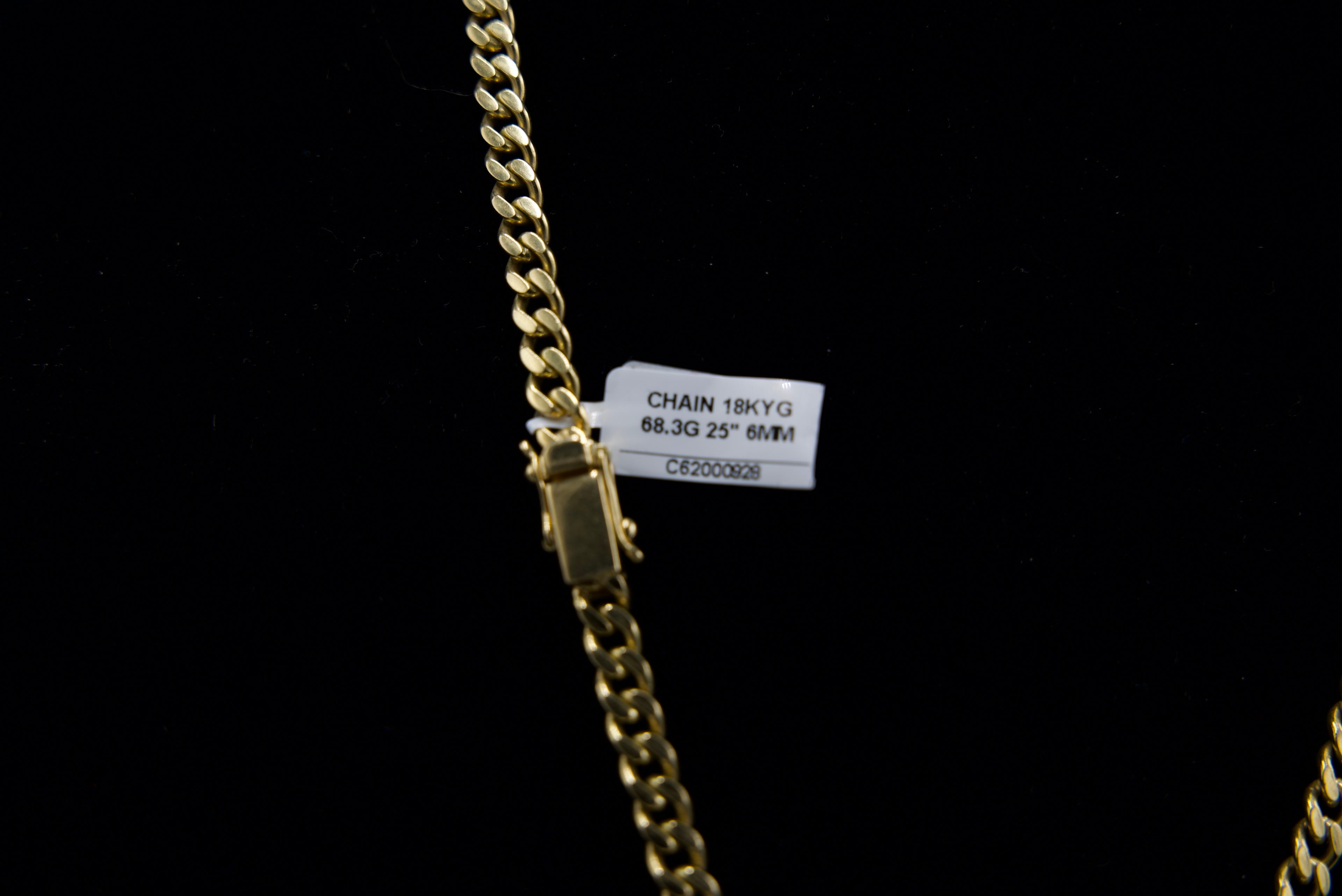 Gold chain with a label on a black background