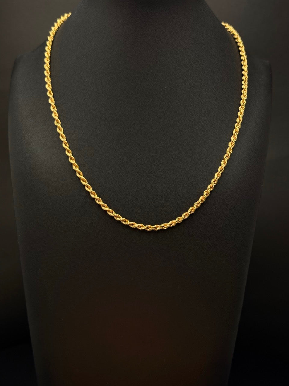 14K yellow gold rope chain measuring 18 inches long and 2.75mm wide, weighing 13.5 grams, displayed on a black jewelry bust.