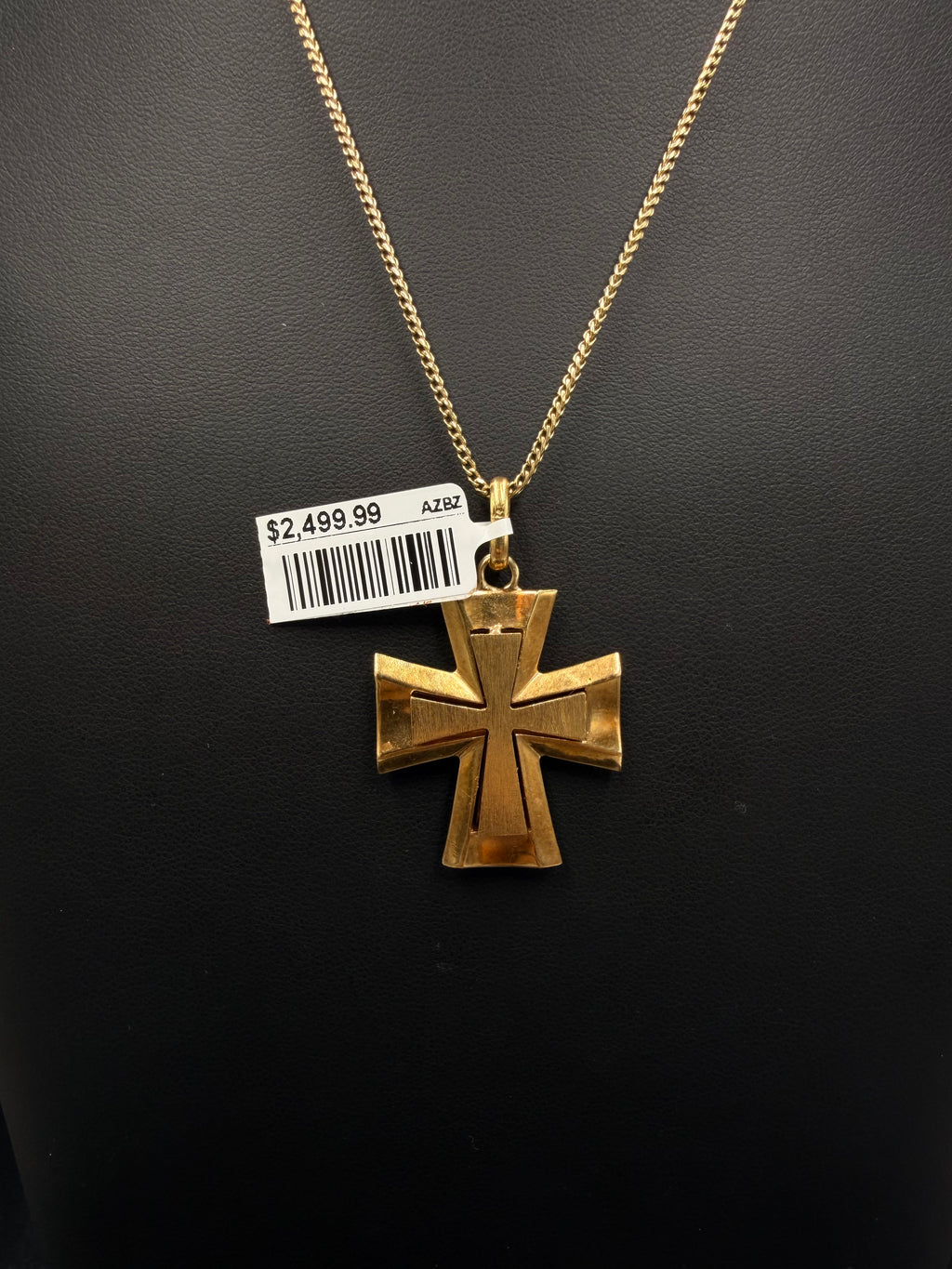 Front of 18K yellow gold flared cross pendant on a gold chain